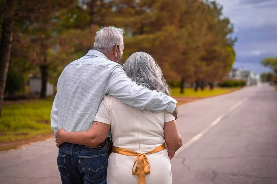 An older couple walking together outdoors